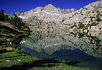 Lake shoreline curving into the expansive view of Sixty Lakes Basin