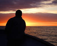 Sunset on a boat near the Equator in the Galapagos Islands. 