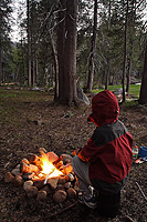 Camper warming by a campfire