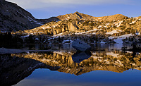 Alpenglow on Hell For Sure Pass reflected in Disappointment Lake.
