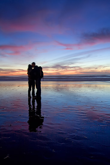 couple kissing sunset. Couple kissing at sunset on