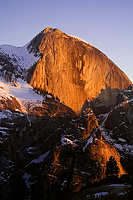 The face of Half Dome lit up red at Sunset