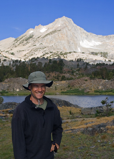 portrait of greg cope posing below North Peak