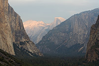Telephoto taken from Tunnel View of half dome with faint sunset colors over shadowed yosemite valley